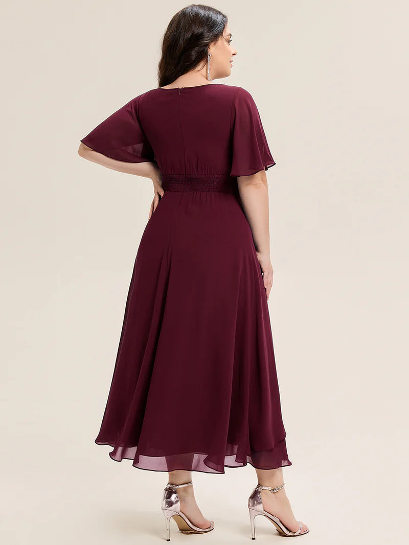 Burgundy plus size wedding guest dress with short sleeves, rhinestone embellishment and midi length.
