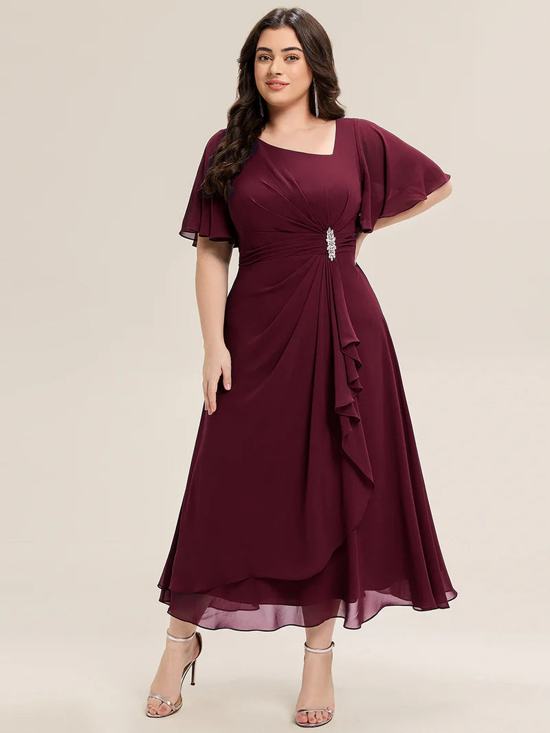 Burgundy plus size wedding guest dress with short sleeves, rhinestone embellishment and midi length.