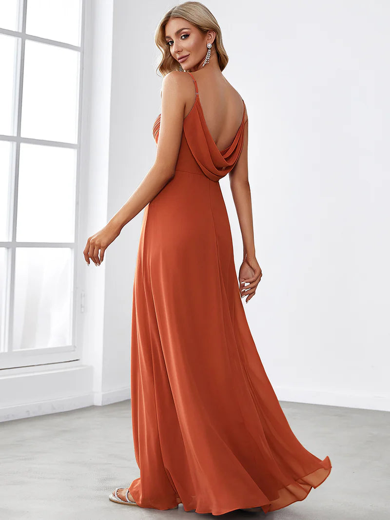 Sleeveless burnt orange bridesmaid dress with spaghetti straps.