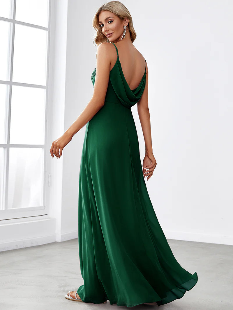 Sleeveless dark green bridesmaid dress with spaghetti straps.
