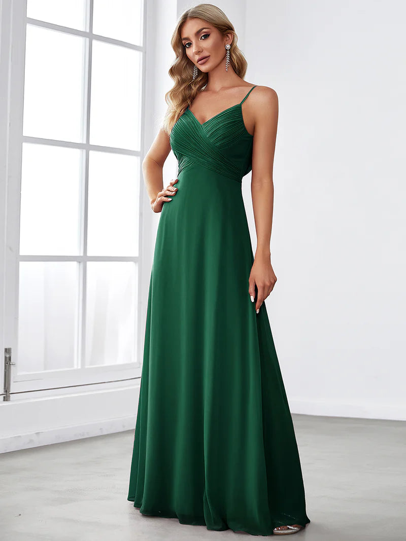 Sleeveless dark green bridesmaid dress with spaghetti straps.