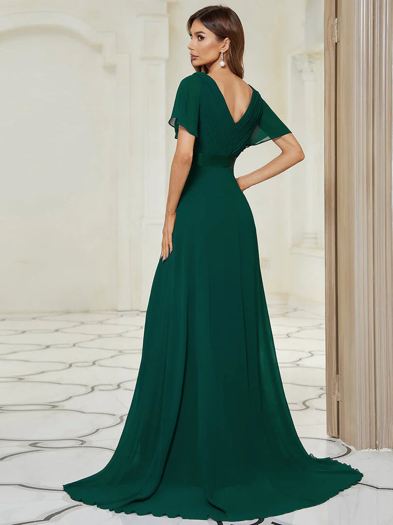 Dark green formal dress in chiffon with satin band and short sleeves.