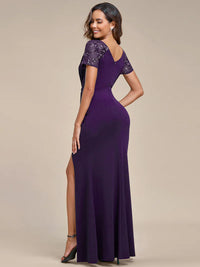 An elegant plus size mother of the bride long deep purple applique cap sleeved evening dress, ruched at the middle.