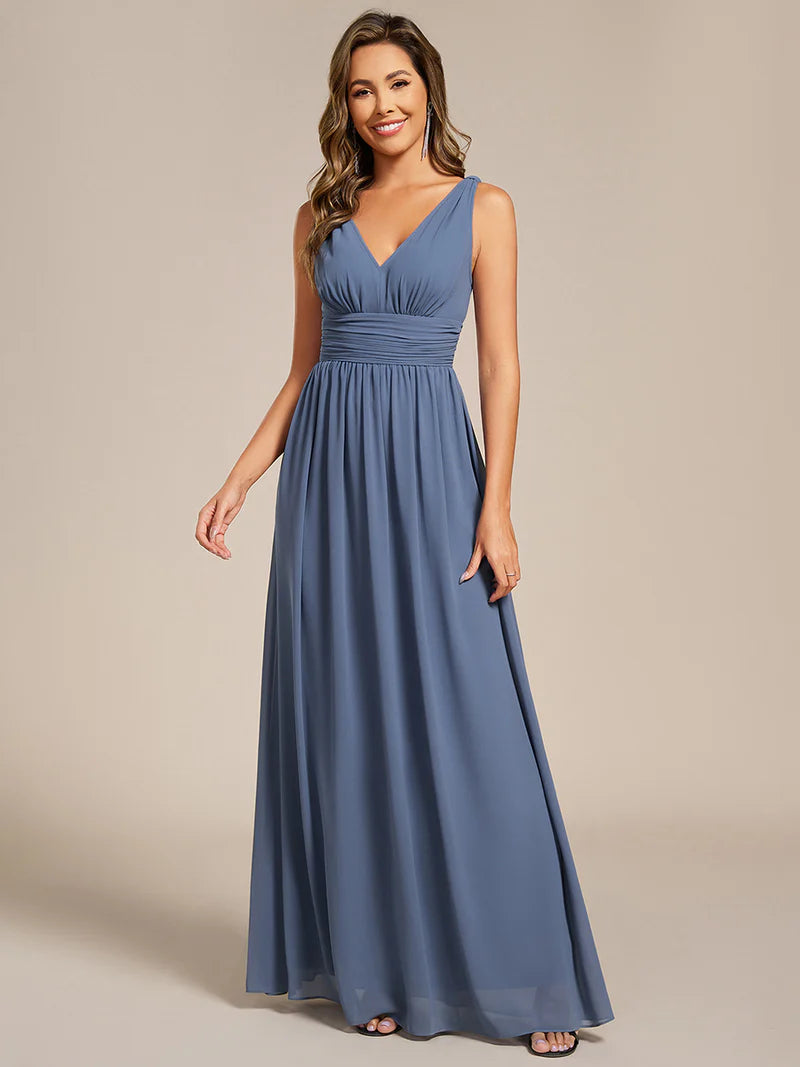 Dusty blue bridesmaid dress with double v-neck and chiffon.