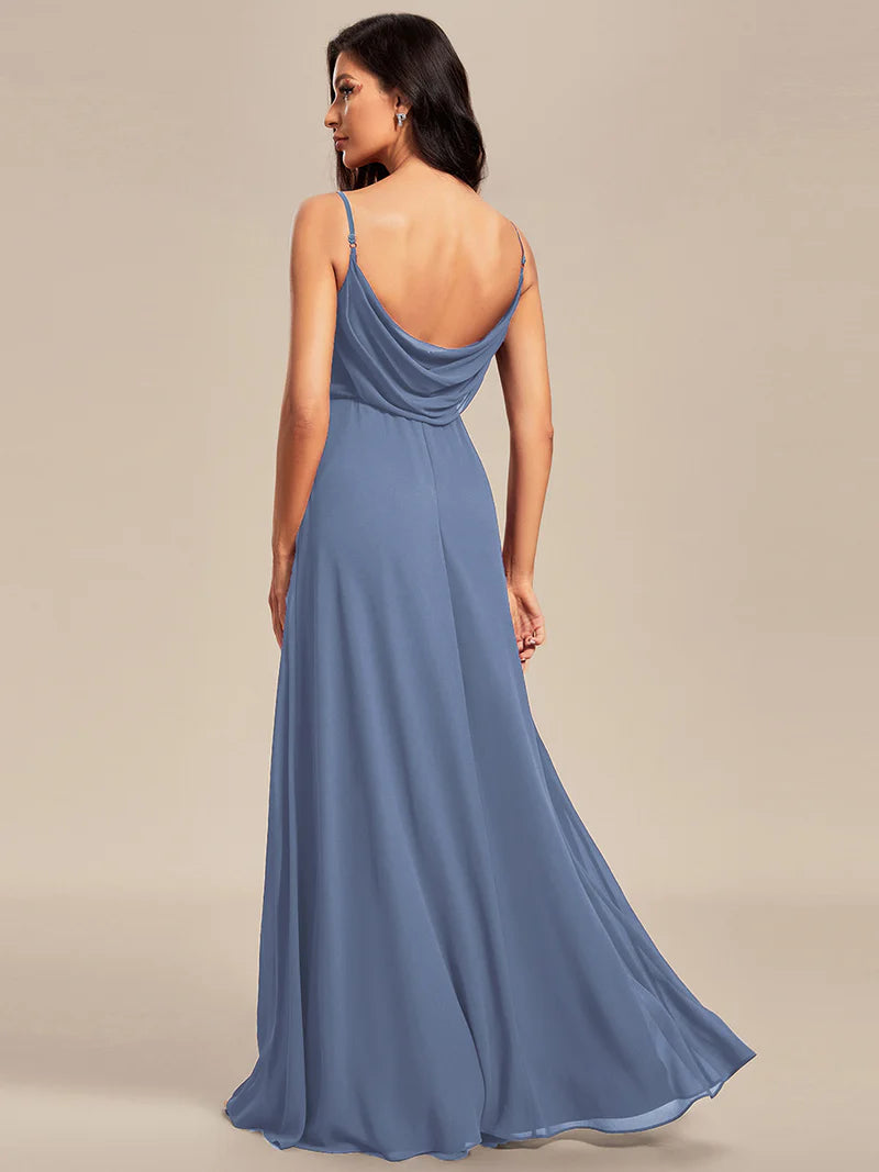 Sleeveless dusty blue bridesmaid dress with spaghetti straps.