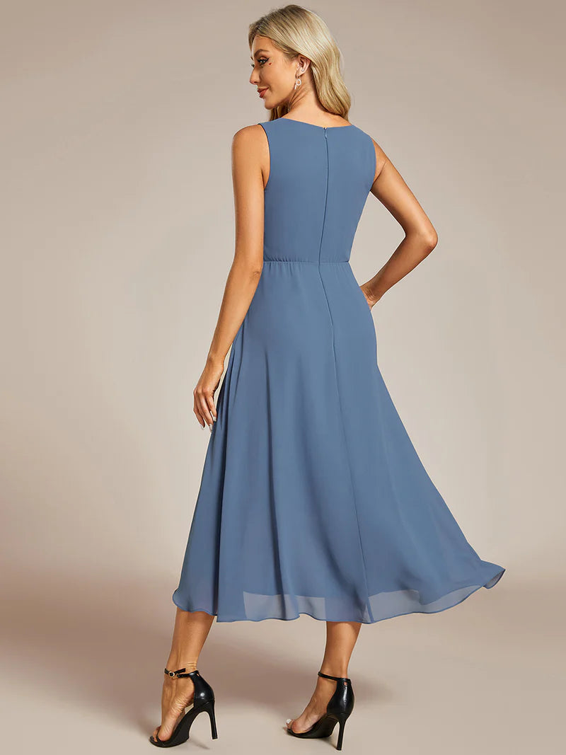 Dusty blue cocktail formal dress in chiffon with applique detail and sleeveless.