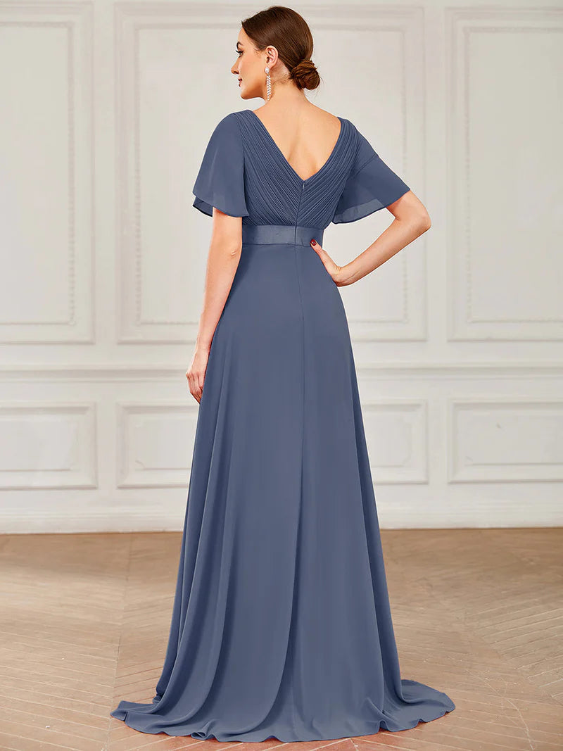 Dusty blue formal dress in chiffon with satin band and short sleeves.