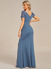An elegant mother of the bride long dusty blue applique cap sleeved formal or evening dress, ruched at the middle.