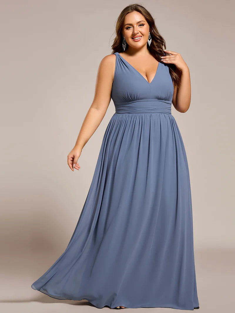 Dusty blue plus sized bridesmaid dress with double v-neck and chiffon.