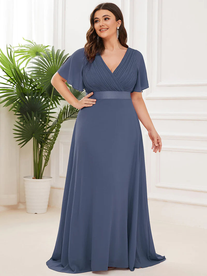 Dusty blue plus size mother of the bride dress in chiffon with short sleeves and a satin band.