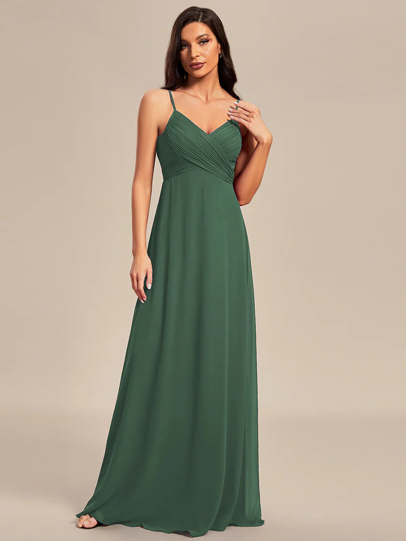 Sleeveless eucalyptus bridesmaid dress with spaghetti straps.