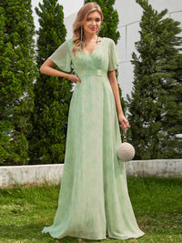 Floral green bridesmaid dress or formal dress in chiffon with satin band and short sleeves.