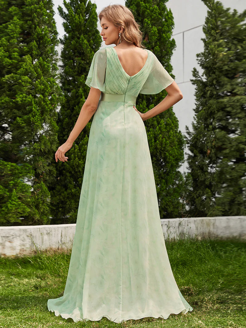 Floral green formal dress in chiffon with satin band and short sleeves.