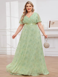 Floral green plus size bridesmaid dress or formal dress in chiffon with short sleeves and a satin band.