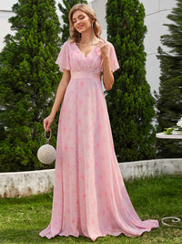 Floral pink bridesmaid dress or formal dress in chiffon with satin band and short sleeves.