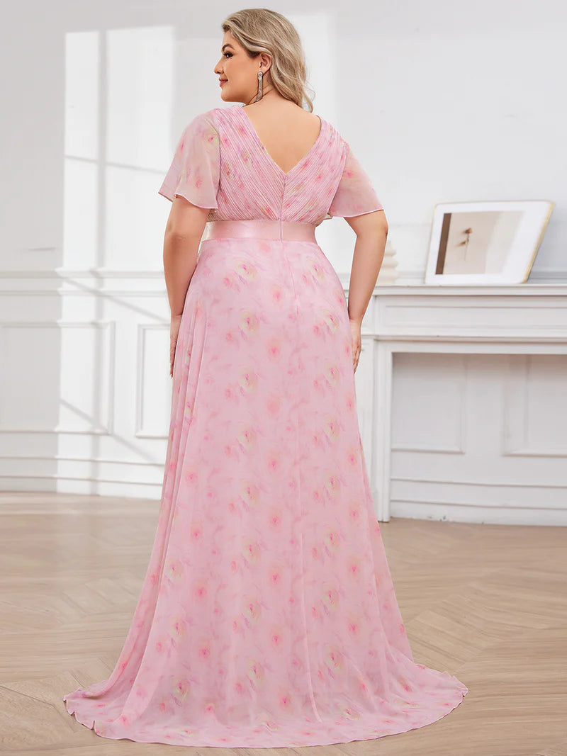 Floral pink plus size bridesmaid dress or formal dress in chiffon with short sleeves and a satin band.