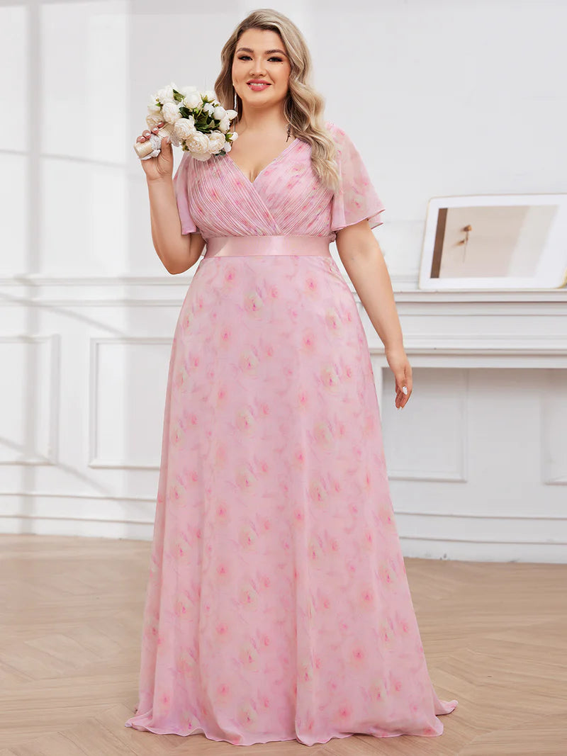 Floral pink plus size mother of the bride dress in chiffon with short sleeves and a satin band.