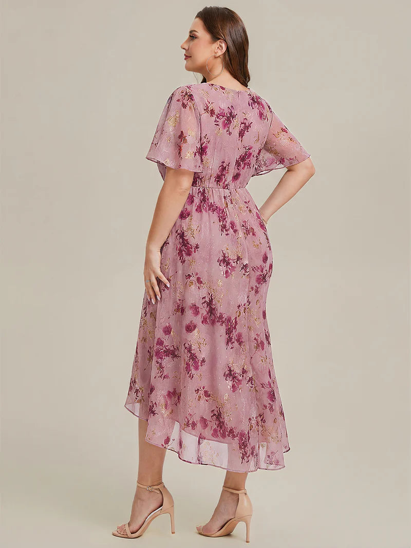 Floral plus size wedding guest or evening dress with short sleeves.