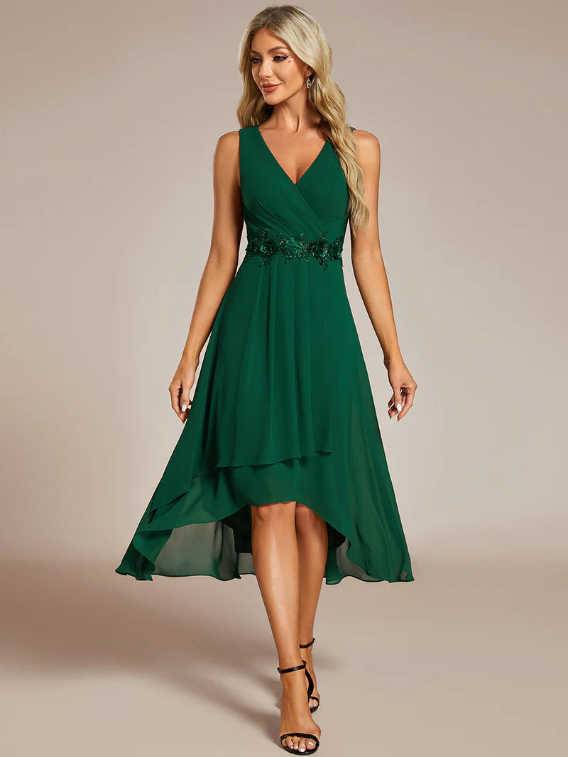 Green cocktail formal dress in chiffon with applique detail and sleeveless.