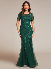 Green Mother of the bride or formal dress, short sleeve with tulle, lace and sequin detailing.