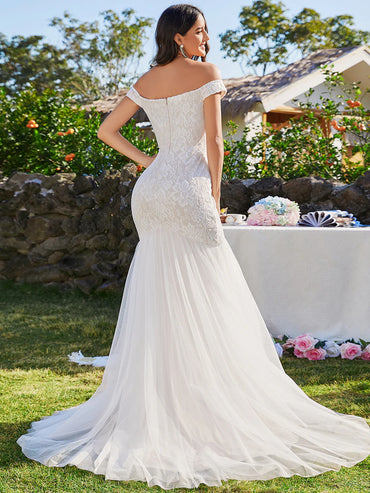 Ivory lace and tulle wedding dress with off the shoulder sleeve. Plus size available.