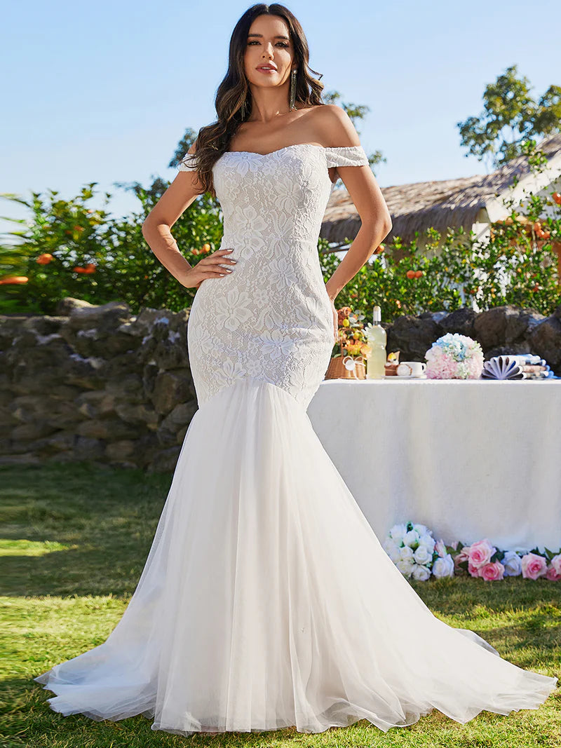 Ivory lace and tulle wedding dress with off the shoulder sleeve. Plus size available.