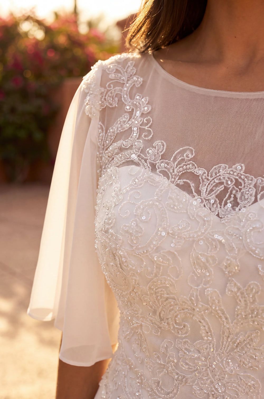 Ivory plus size wedding dress in chiffon with beaded bodice.