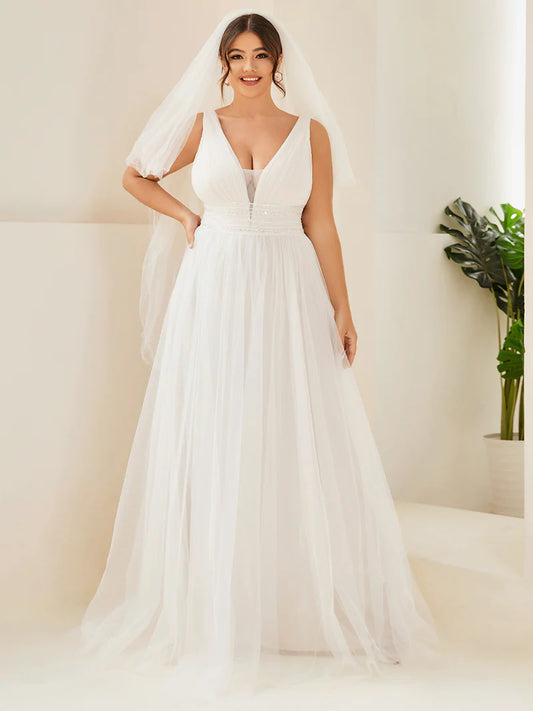 Ivory plus size wedding dress with deep v neck tulle skirt beaded detail.