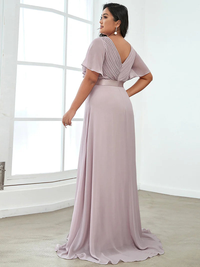 Lilac plus size bridesmaid dress or formal dress in chiffon with short sleeves and a satin band.