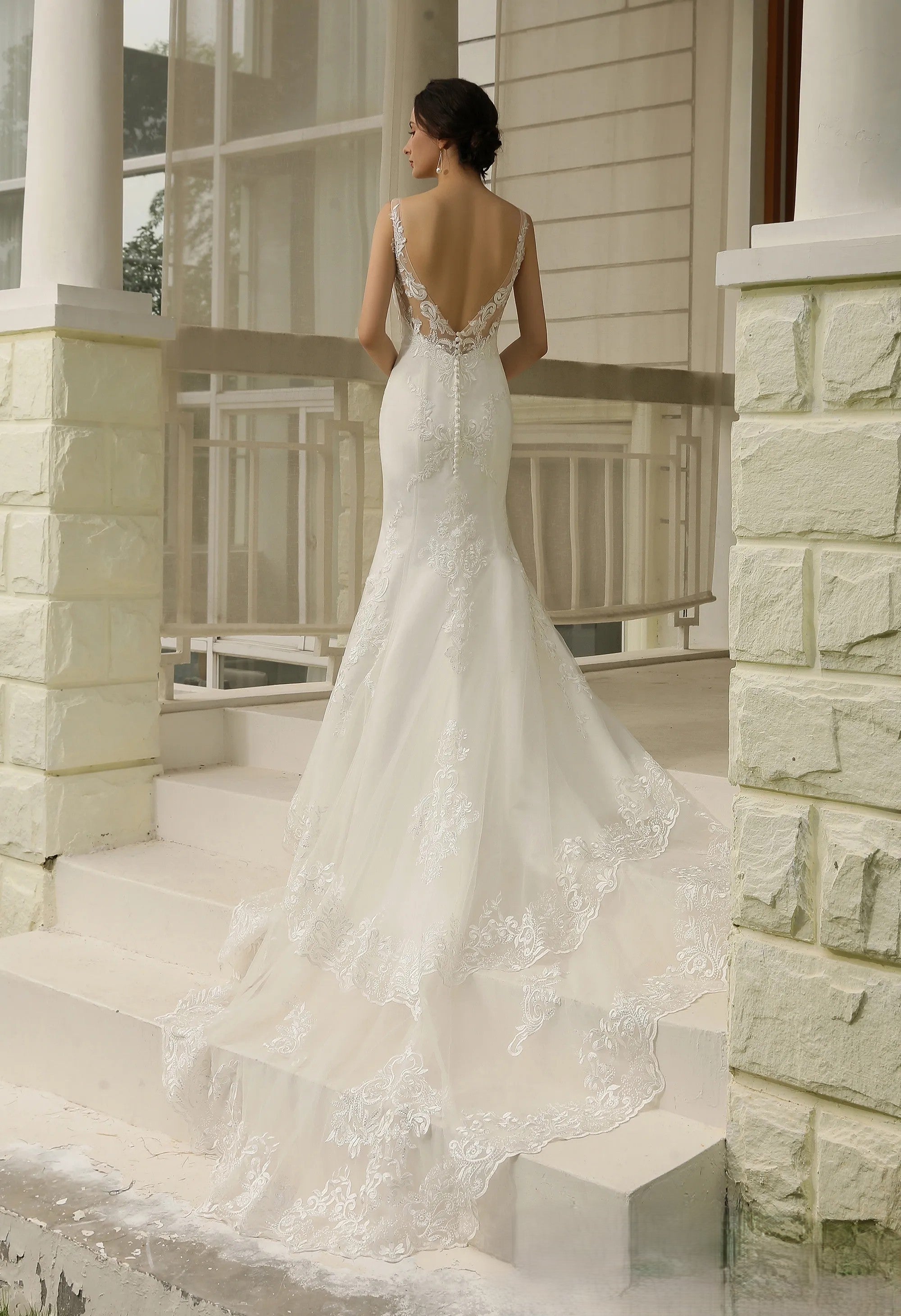 Mermaid lace applique over tulle wedding dress.