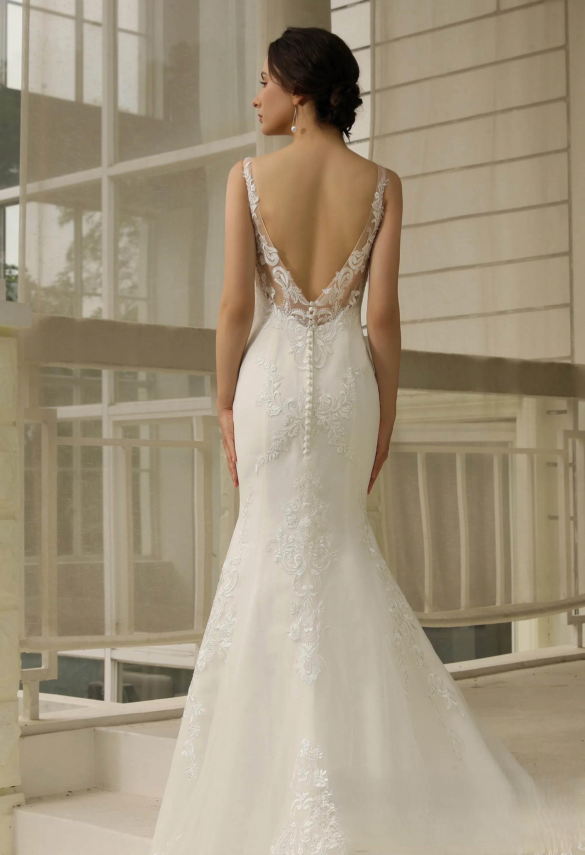 Mermaid lace applique over tulle wedding dress.
