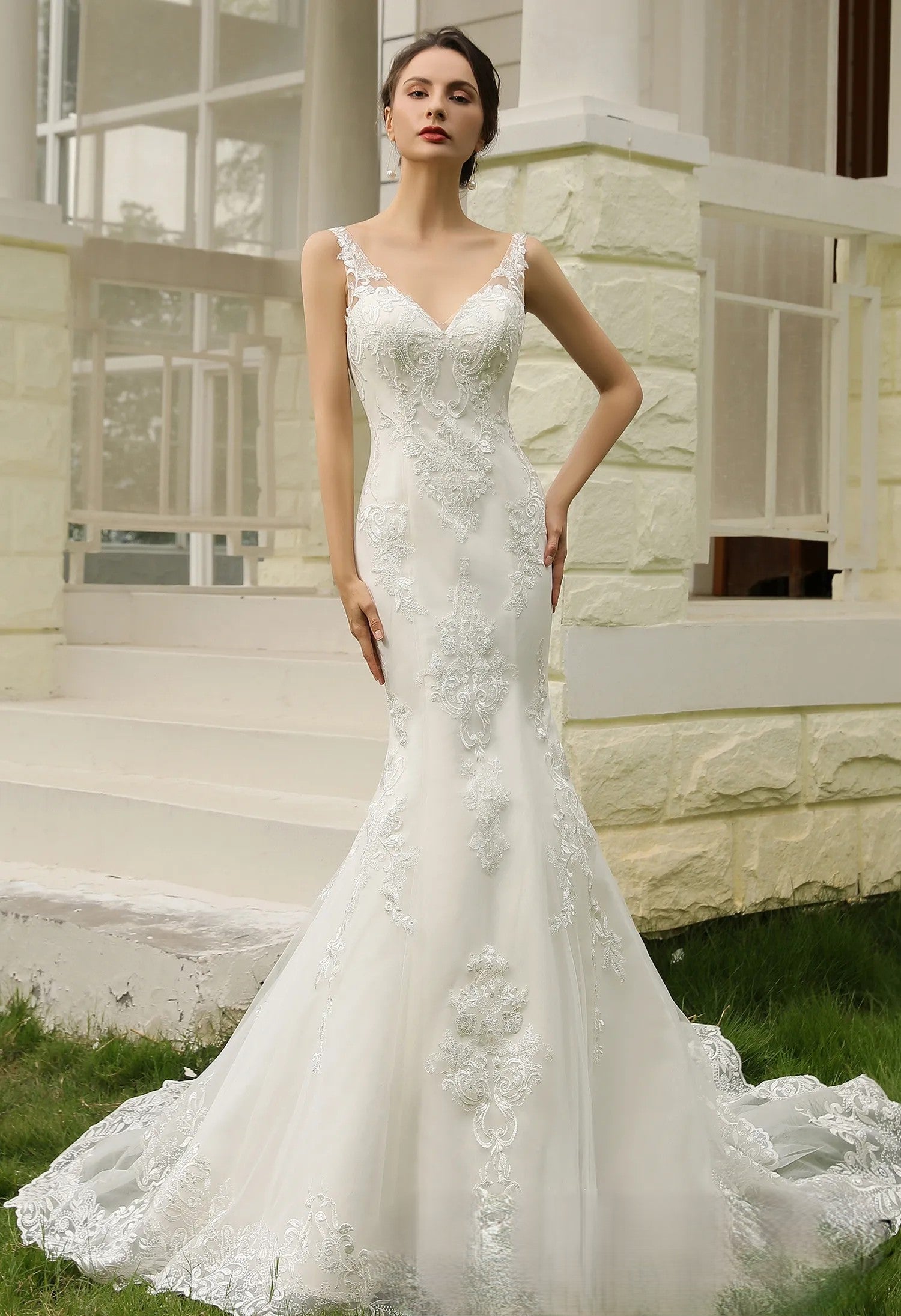 Mermaid lace applique over tulle wedding dress.