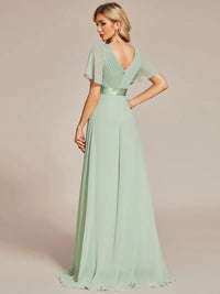 Mint green bridesmaid dress or formal dress in chiffon with satin band and short sleeves.