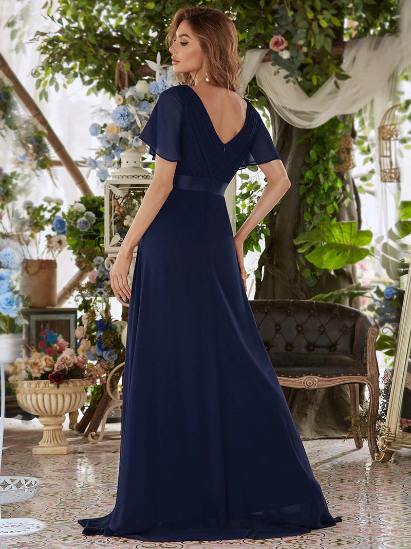 Navy blue formal dress in chiffon with satin band and short sleeves.