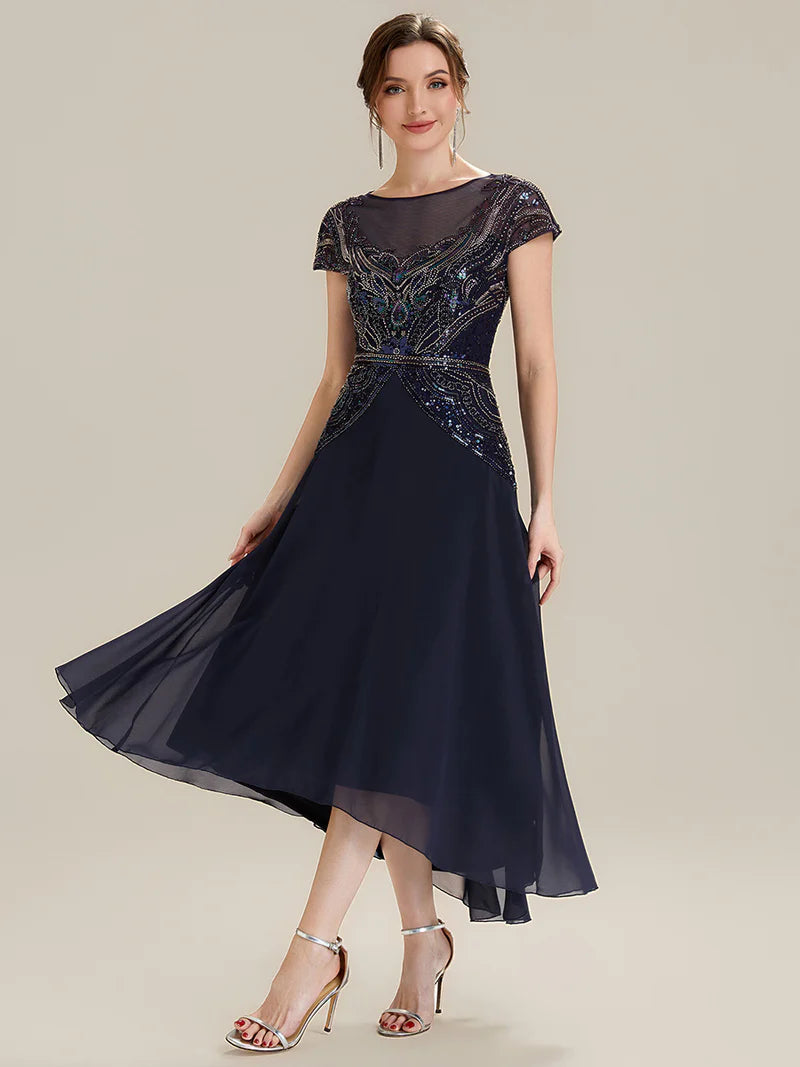 Navy blue mother of the bride dress in tea length short sleeve style with beaded embellishment.