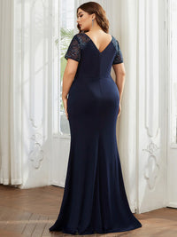 An elegant plus size mother of the bride long navy blue applique cap sleeved evening dress, ruched at the middle.