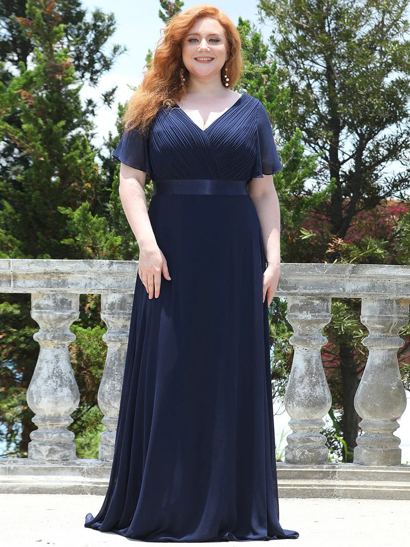 Navy Blue plus size mother of the bride dress in chiffon with short sleeves and a satin band.