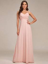 Sleeveless pink bridesmaid dress with spaghetti straps.