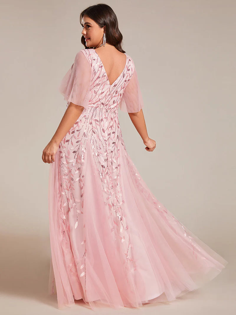 Pink plus size mother of the bride dress with short sleeves and flowing tulle.