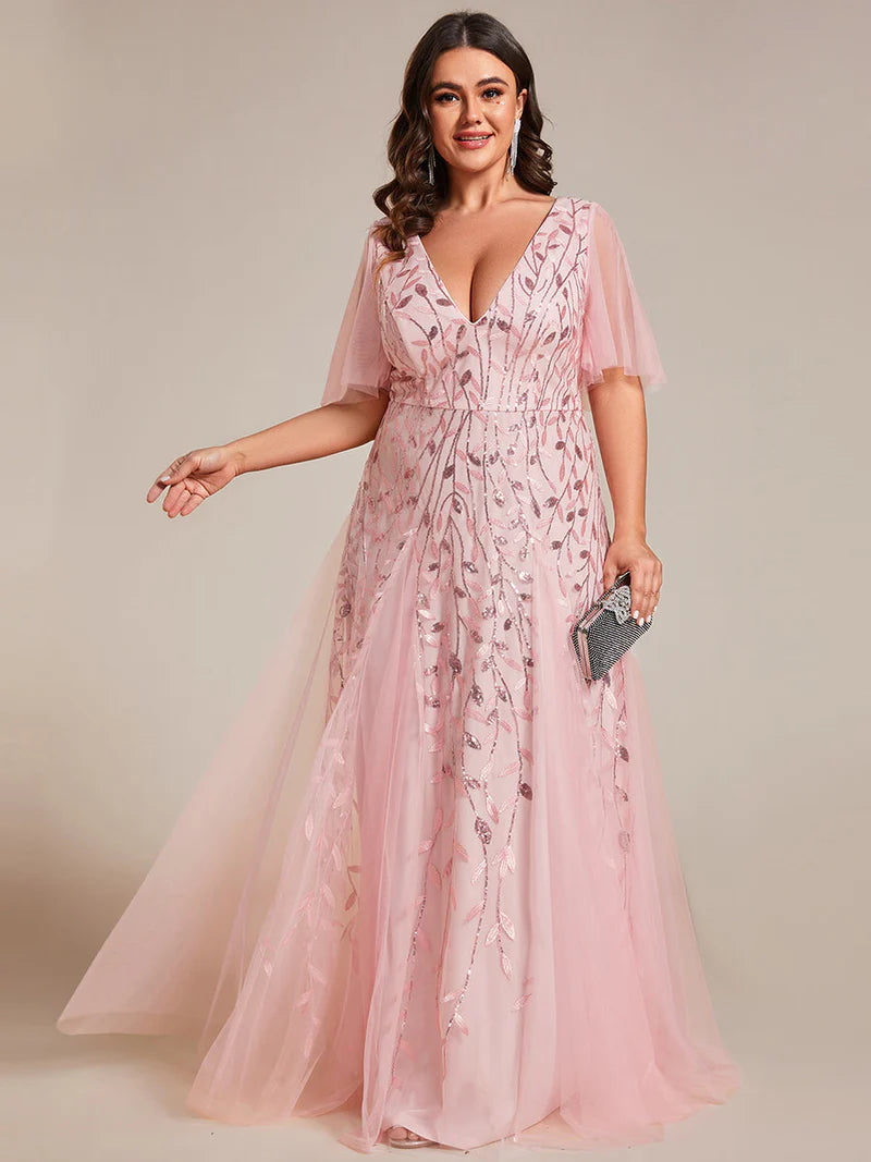 Pink plus size mother of the bride dress with short sleeves and flowing tulle.