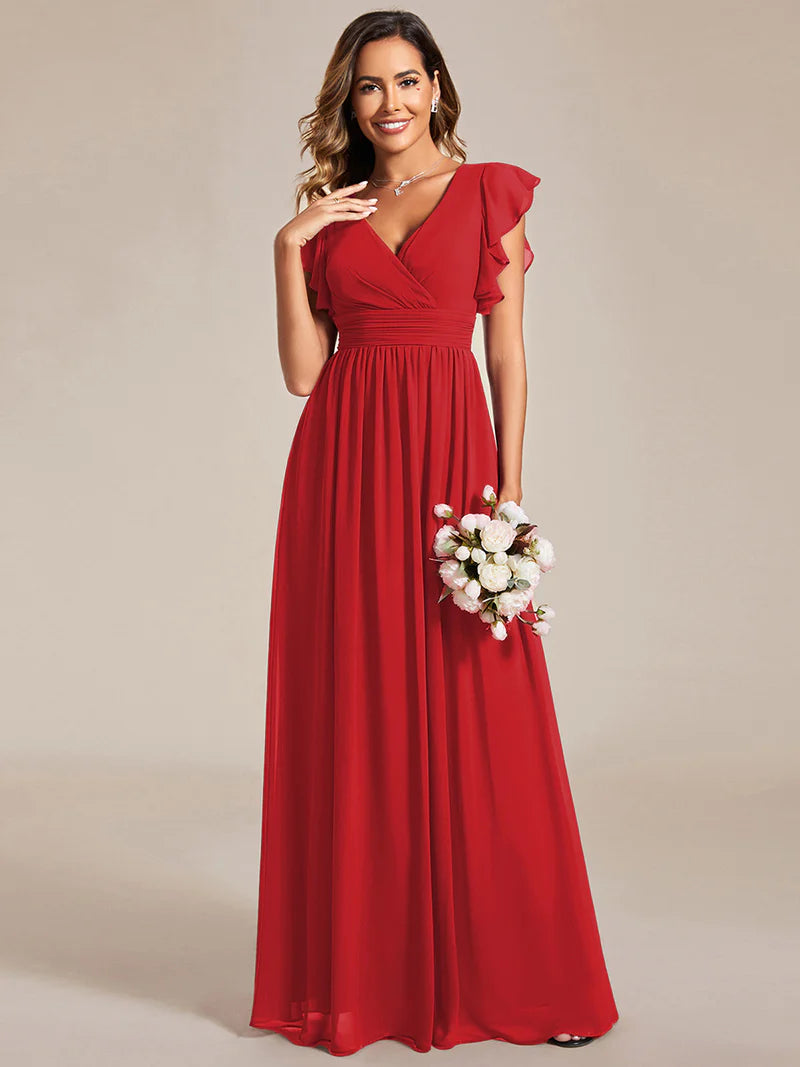 Red bridesmaid dress with ruffle sleeve and open back detail.
