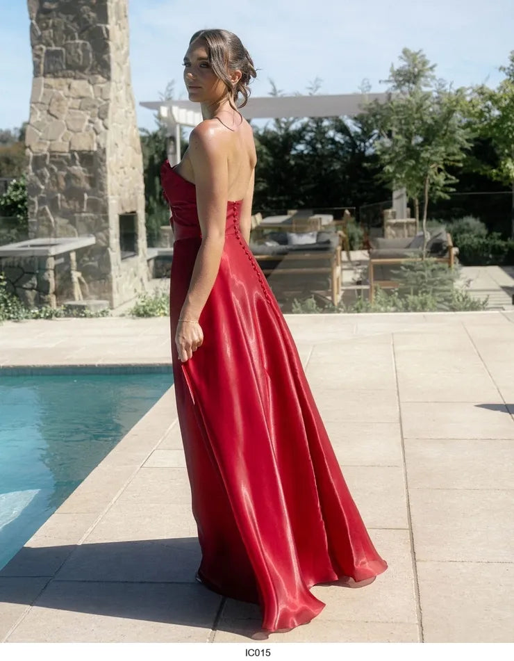 Red satin and organza strapless formal dress with button detail down the back.