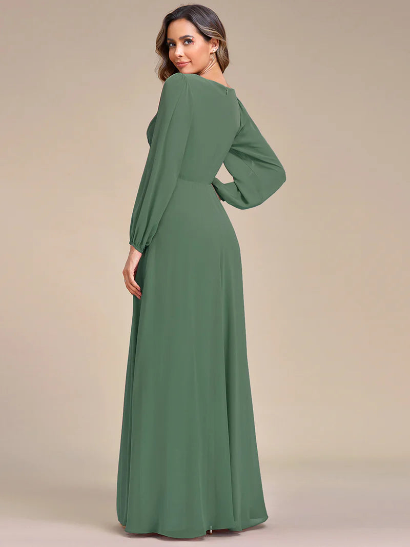 Sage green long sleeve formal dress with applique detail.