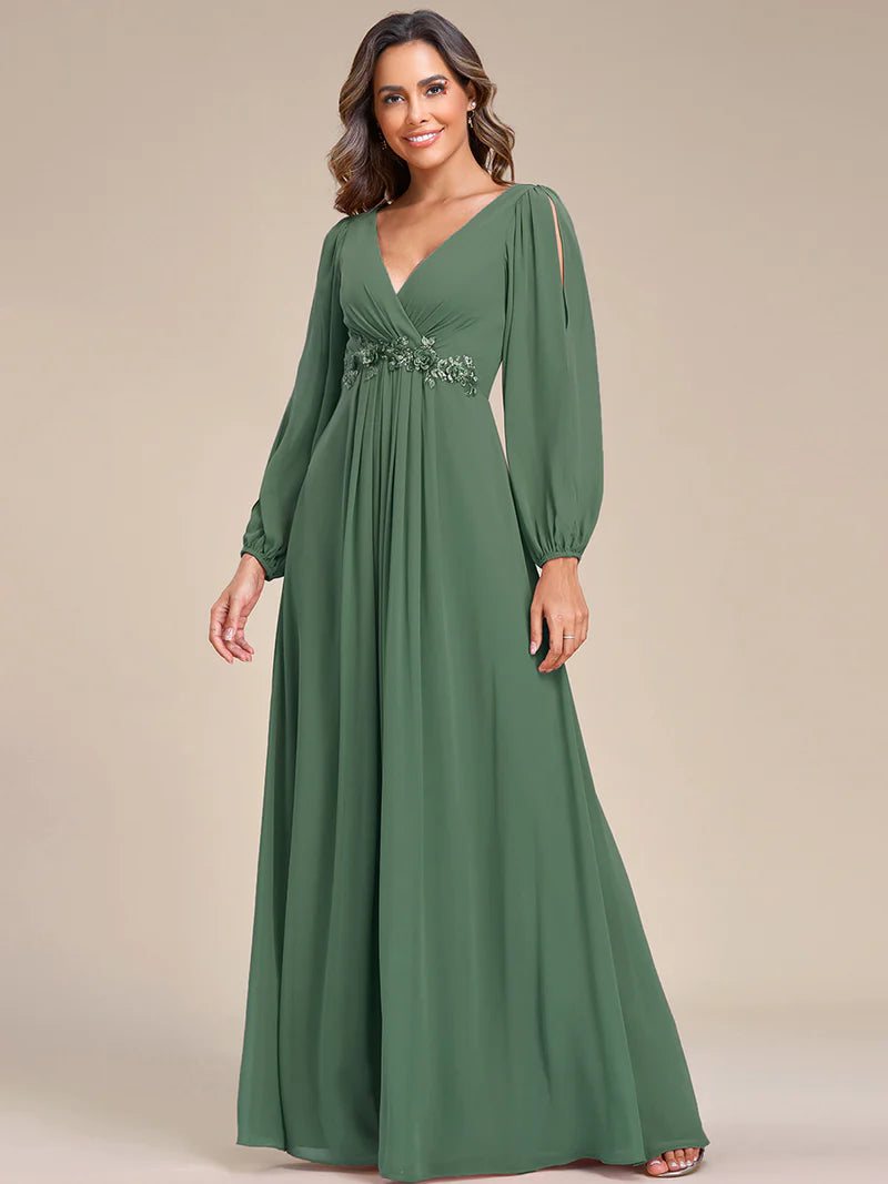 Sage green long sleeve formal dress with applique detail.
