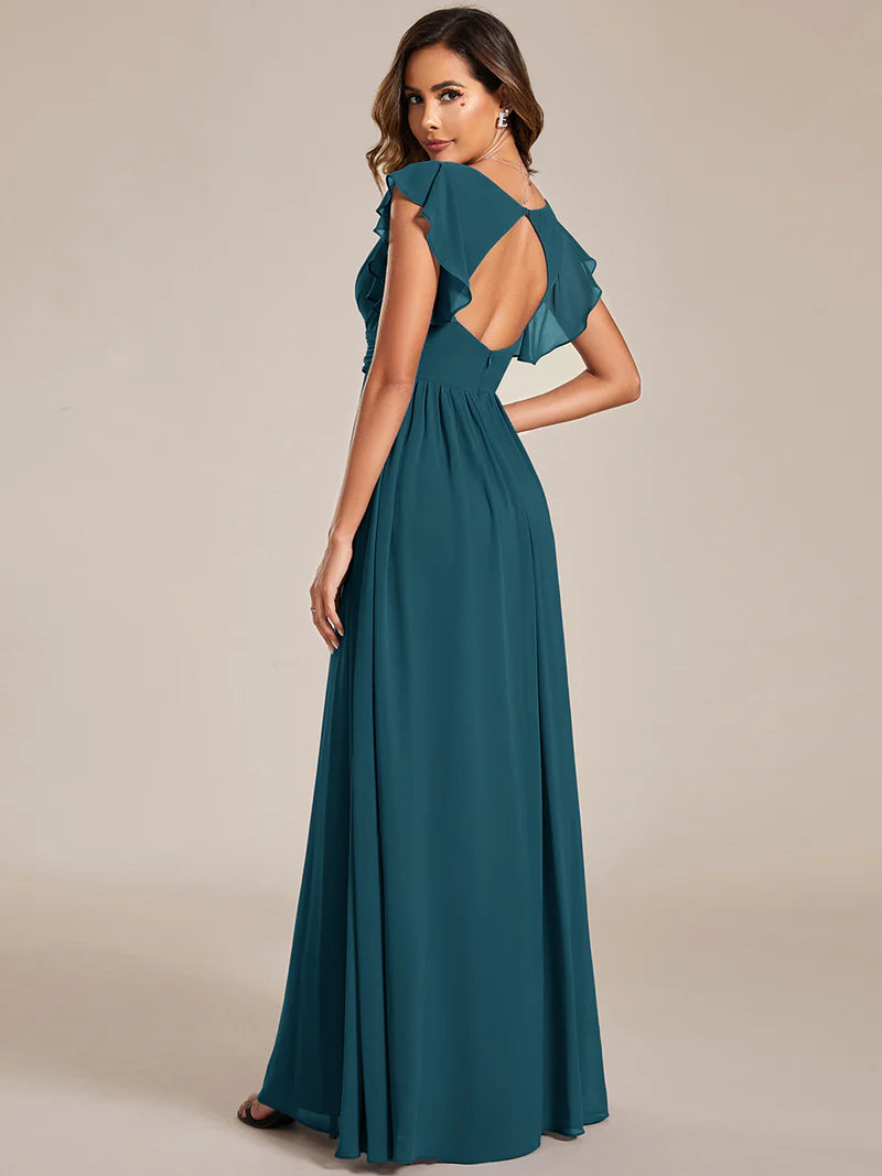Teal bridesmaid dress with ruffle sleeve and open back detail.