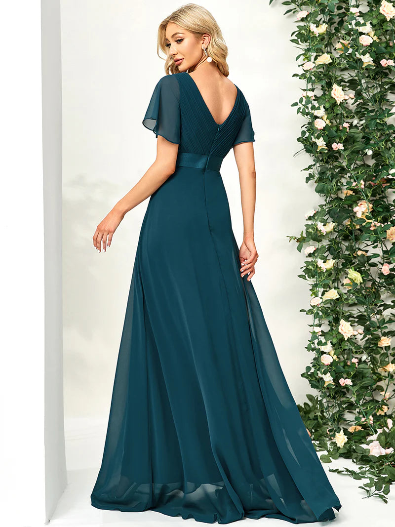 Teal formal dress in chiffon with satin band and short sleeves.