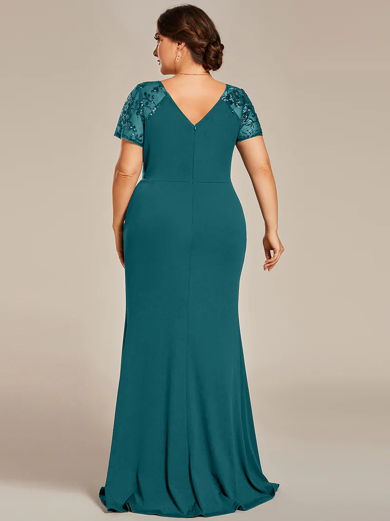 An elegant plus size formal-dress-long teal applique cap sleeved evening dress, ruched at the middle.