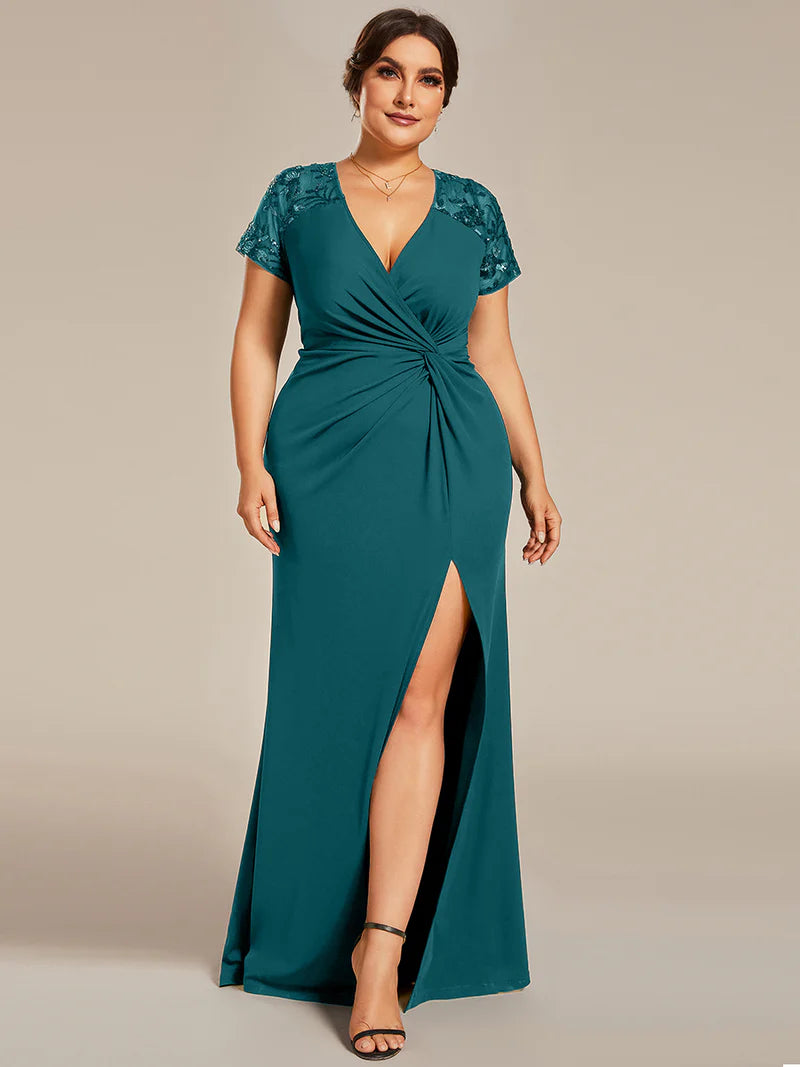 An elegant plus size formal-dress-long teal applique cap sleeved evening dress, ruched at the middle.