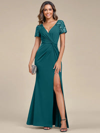 An elegant mother of the bride long teal applique cap sleeved formal or evening dress, ruched at the middle.