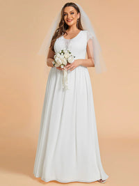 White plus size wedding dress with lace applique detail and chiffon skirt.